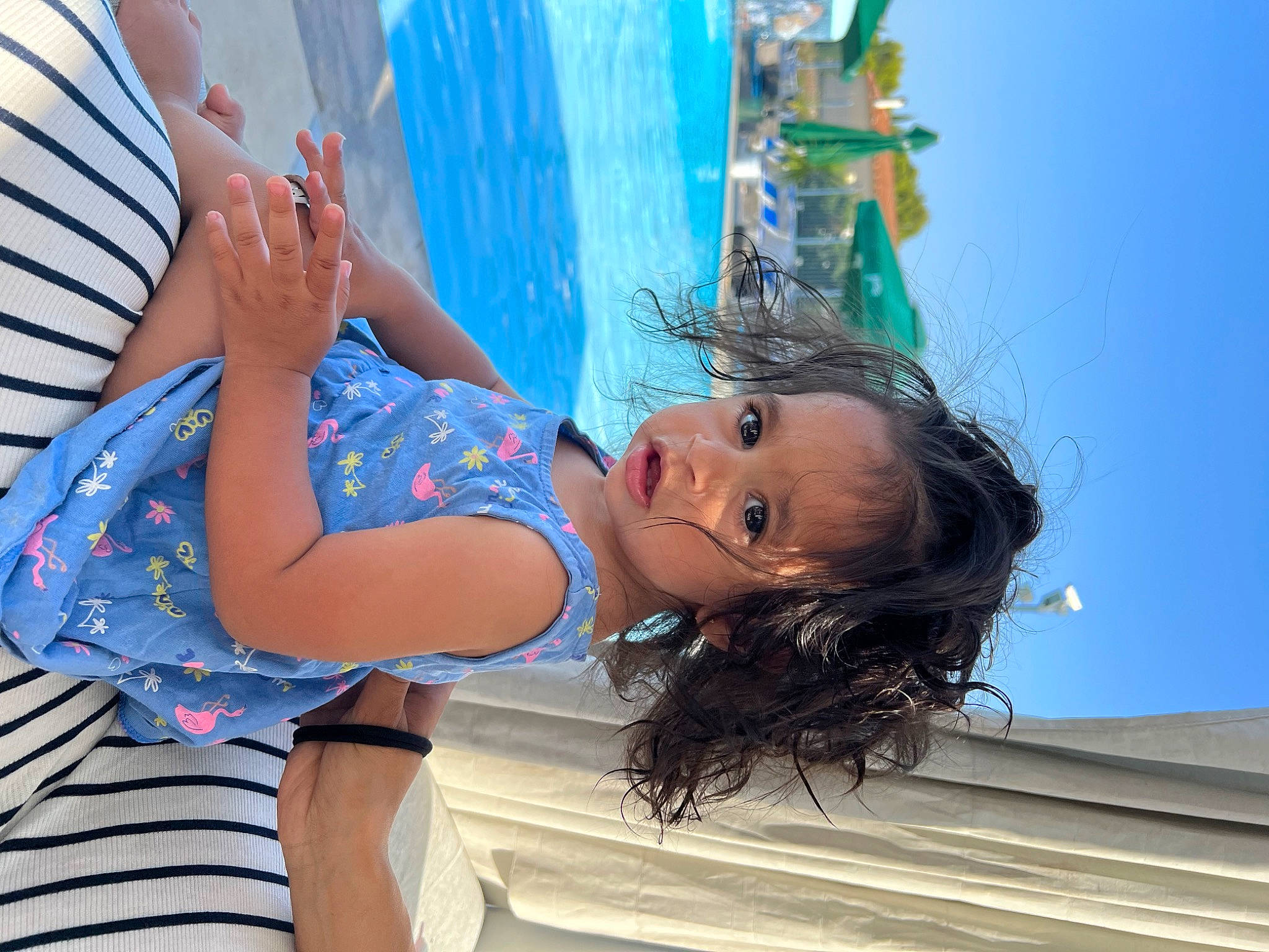 Shanna participe au concours pour gagner de l'argent avec cette photo : azure, black_hair, blond, brown_hair, child, electric_blue, fun, happy, human_leg, leisure, long_hair, people_in_nature, person, recreation, sitting, sky, smile, swimming_pool, thigh, vacation