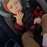 Cooper joined the competition — help win amazing prizes! toddler, child, car_seat, beanie, orange_hat, blue_eyes, finger_in_mouth, red_plaid_shirt, brown_pants, car_interior, seatbelt, safety_harness, curious_expression, casual_clothing, cute, indoors, young_child, portrait, infant, baby