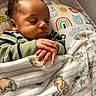 baby, sleeping, blanket, teddy_bear, hands, pillow, rainbow, sun, animal_prints, cozy, infant, child, cute, peaceful, resting, curly_hair, soft_lighting, bedroom, comfort, portrait