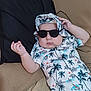 Manil participe au concours pour gagner de l'argent avec cette photo : baby, child, sunglasses, hat, tropical_print, couch, pillow, relaxing, indoor, clothing, infant, cute, fashion, person, portrait, casual, summer_style, skin, hand, face