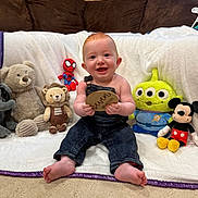 Kyvin joined the competition — help win amazing prizes! alien_toy, baby, blanket, carpet, child, couch, cute, denim_overalls, happy, holding, indoor, infant, lion_plush, mickey_mouse, plush_toys, sitting, smiling, spiderman_toy, teddy_bear, wooden_plaque