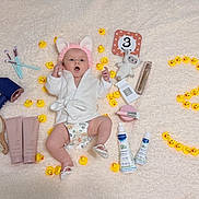 Riana joined the competition — help win amazing prizes! baby, baby_brush, baby_care_products, baby_robe, baby_shoes, body_lotion, cosmetics, cute, diaper, hair_dryer, indoor, makeup_brush, milestone_photo, number_three, pink_bunny_ears, portrait, rubber_duck, soft_blanket, surprised_expression, toy_lamb