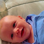 Toby joined the competition — help win amazing prizes! baby, baby_bottle, blue_clothing, bottle, cheeks, child, closeup, cute, eyes, face, happy, head, infant, lying_down, mouth, portrait, skin, smile, soft_surface, young