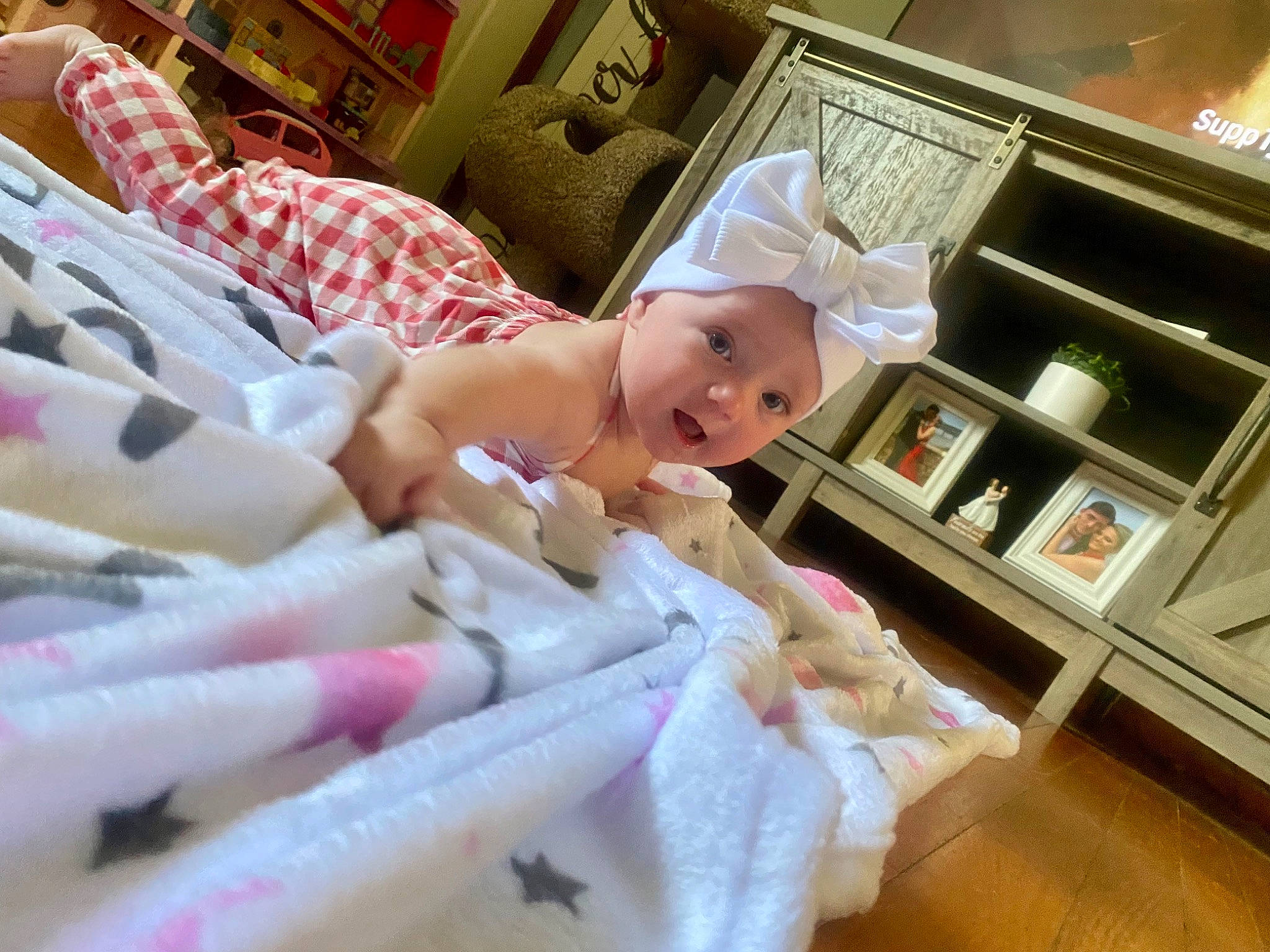 Legacy joined the competition — help win amazing prizes! baby, baby_toddler_clothing, bed, bed_sheet, bedding, bedroom, bookcase, cabinetry, comfort, drawer, headwear, linens, magenta, nightstand, person, pillow, pink, room, shelf, smile