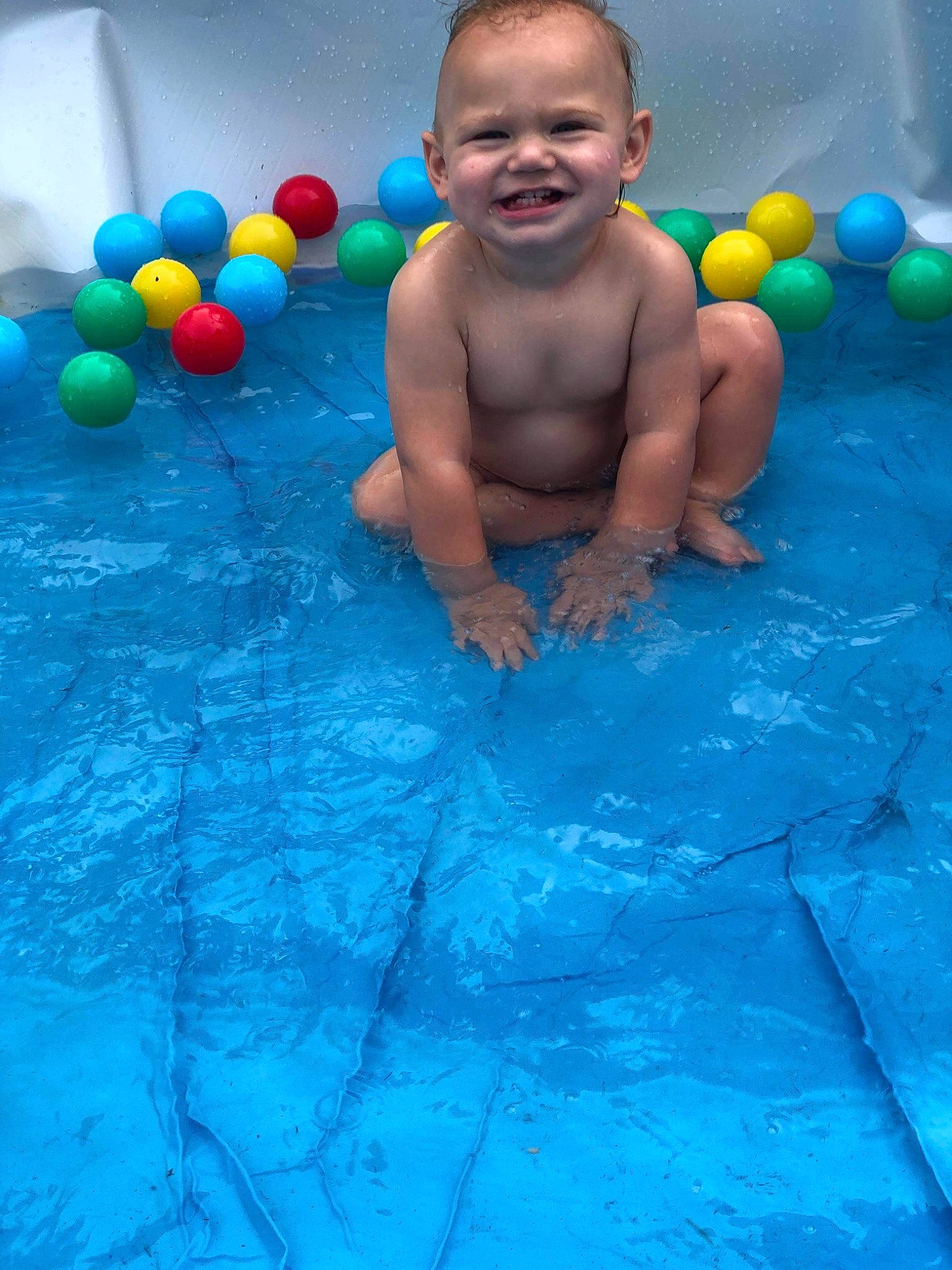 Gary is registered to the contest to win money with this photo: aqua, azure, baby, beauty, blue, child, electric_blue, flooring, fun, happy, joy, leisure, party_supply, people, person, play, product, recreation, smile, summer