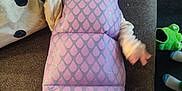 Maja is registered to the contest to win money with this photo: baby, child, costume, purple, monster, hood, teeth, yawning, crying, couch, indoor, foot, toy, blanket, clothing, person, infant, cute, padded, fabric