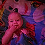 baby, child, blanket, colorful, cartoon, face, smile, fingers, hand, cozy, infant, cute, wrapped, soft_light, indoors, portrait, happy, young, pink_tint, fabric