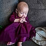 Maja is registered to the contest to win money with this photo: baby, blanket, child, couch, cozy, cute, face, feet, hands, homedecor, indoor, infant, nibbling, portrait, purple_dress, relaxing, sitting, soft_lighting, textile, thoughtful