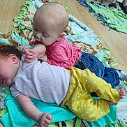 Maja joined the competition — help win amazing prizes! baby, infant, child, floor, blanket, clothing, play, cuddle, jeans, pink_shirt, yellow_pants, feet, wooden_floor, toddler, cute, indoor, person, two_children, lying_down, happy