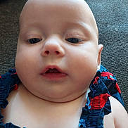 Maja joined the competition — help win amazing prizes! baby, face, child, closeup, person, skin, infant, portrait, clothing, couch, texture, indoors, cute, expression, chubby_cheeks, blue, red, ruffles, young, head
