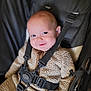 baby, beige_clothing, blue_eyes, buckle, car_seat, cheeky, close_up, cute, face, fuzzy_clothing, happy, infant, onesie, portrait, safety_harness, smile, smiling, soft_background, strap, stroller