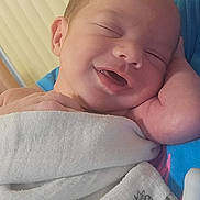 Ollie joined the competition — help win amazing prizes! newborn, baby, smiling, wrapped, blanket, sleeping, peaceful, infant, face, hand, skin, closeup, cuddly, comfort, resting, cute, soft, indoors, portrait, child