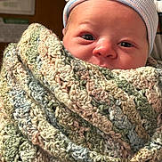 Sterling is registered to the contest to win money with this photo: newborn, baby, infant, child, portrait, face, eyes, wide_eyed, looking_at_camera, knit_cap, hat, blanket, wrapped, cozy, pastel, textile, indoor, close_up, photography, cute