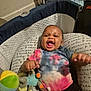 Ja'Leir is registered to the contest to win money with this photo: baby, infant, toy, elephant_toy, cushion, colorful_clothing, tie_dye, smiling, happy, indoor, person, child, fabric, soft_toy, black_clothing, playful, lying_down, cute, expression, baby_bed