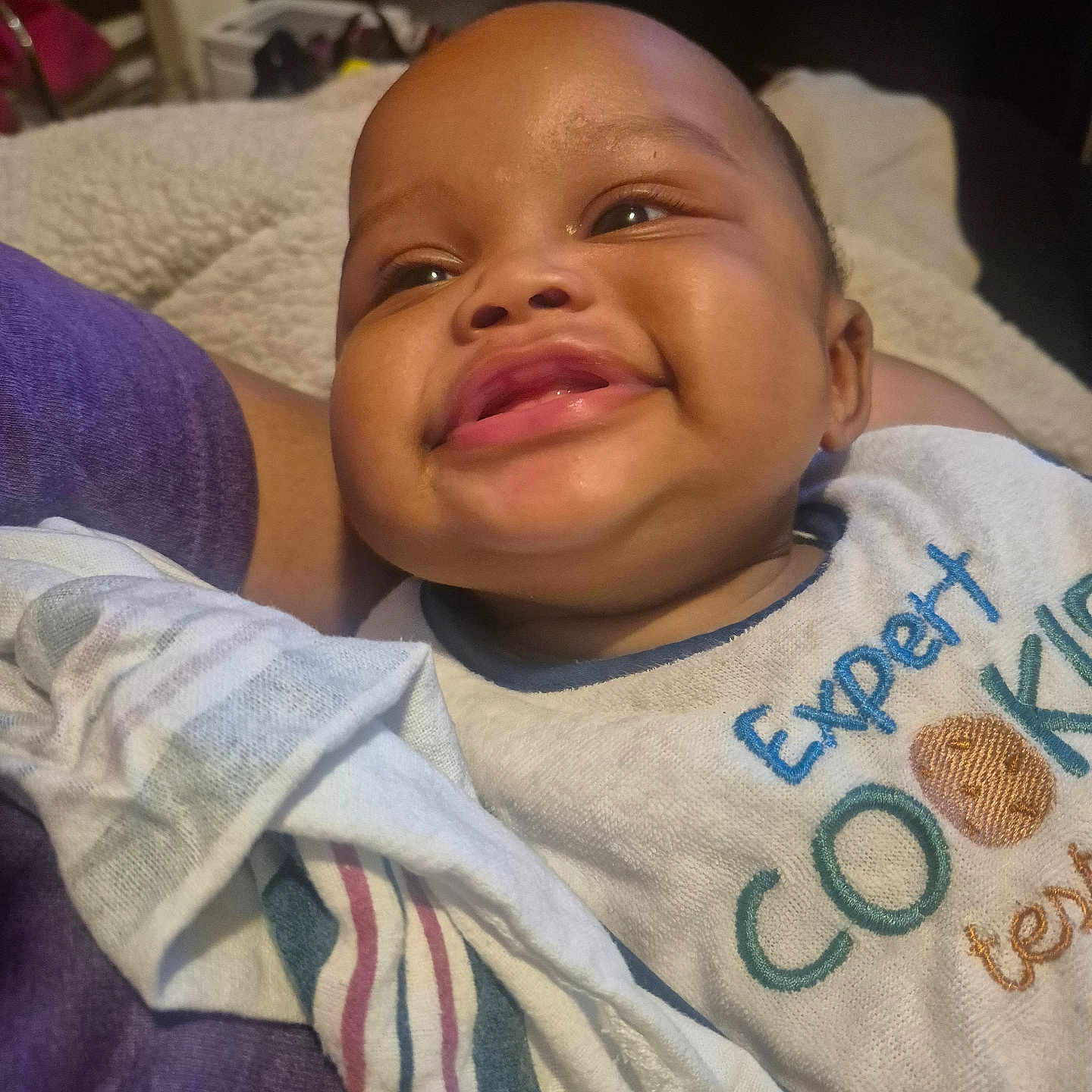 Ja'Leir joined the competition — help win amazing prizes! baby, bib, blanket, child, closeup, clothing, comfort, cozy, cute, fabric, face, happy, head, indoor, infant, person, portrait, skin, smiling, text