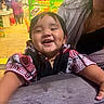 toddler, child, smiling, happy, dimples, table, wood, food_stall, night, market, woman, clothing, portrait, person, indoors, neon_lights, casual, cheerful, face, background