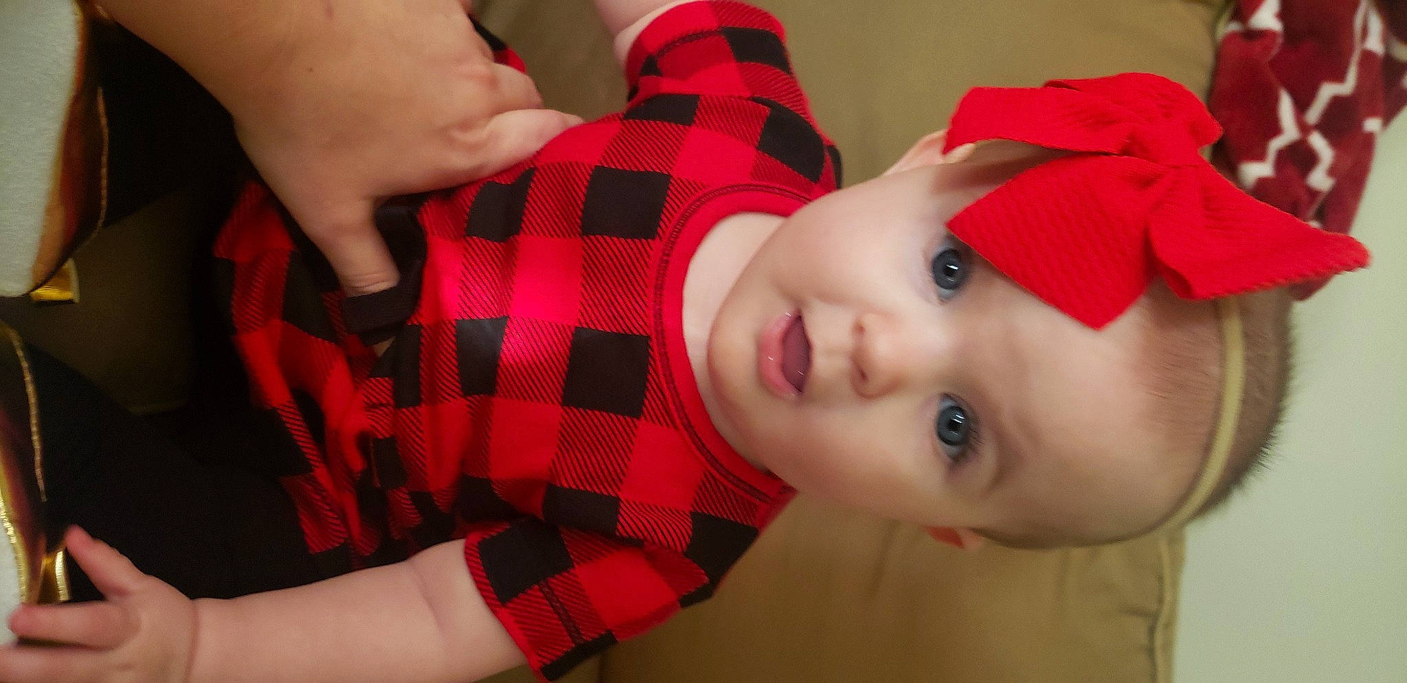 Aiyana is registered to the contest to win money with this photo: arm, baby_toddler_clothing, cheek, chin, eye, eyelash, face, gesture, hand, head, iris, lip, mouth, nose, person, plaid, product, skin, sleeve, tartan