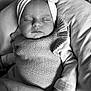 baby, black_and_white, bow, child, closeup, cozy, cute, hand, headband, human, infant, knitwear, newborn, peaceful, person, portrait, resting, sleeping, soft_texture, toddler