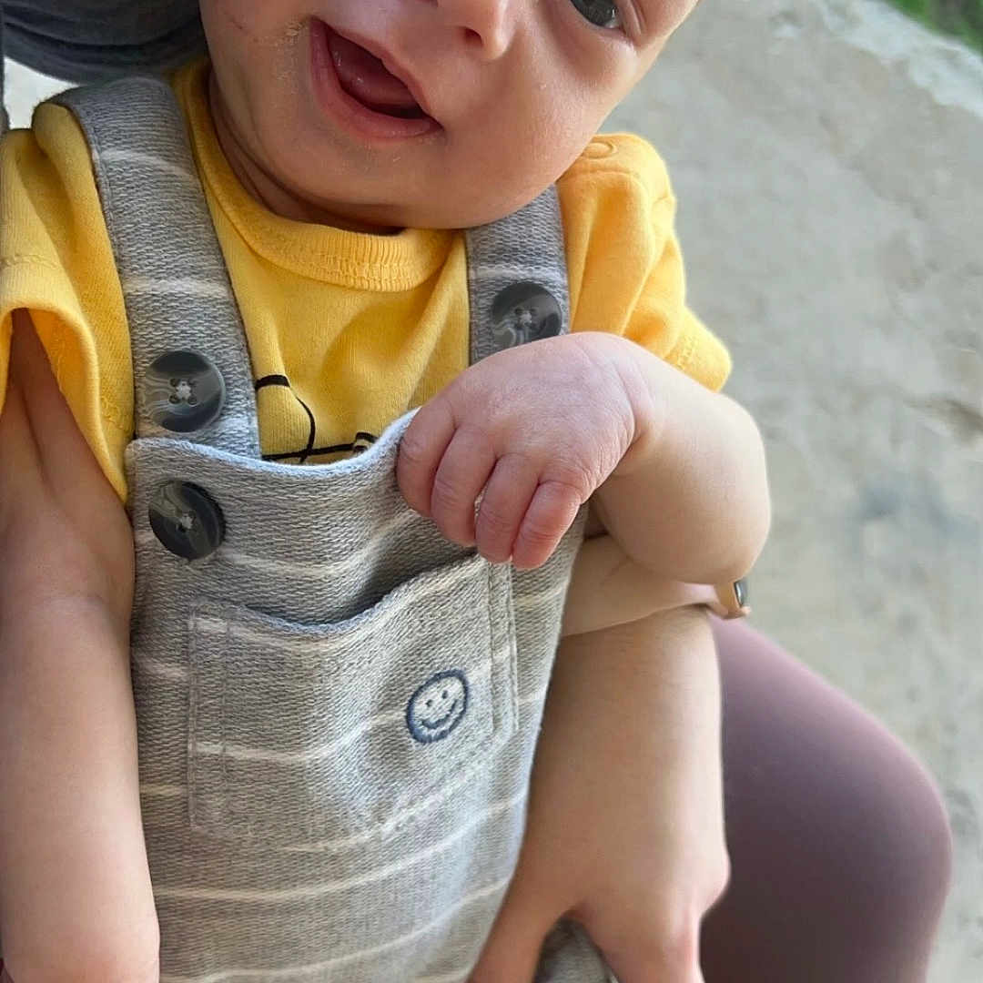 Nolan joined the competition — help win amazing prizes! baby, babylaughing, clothing, coat, dress, face, happy, head, jacket, jeans, laughing, pants, person, photography, portrait, rock, shorts, sitting, smile, vest