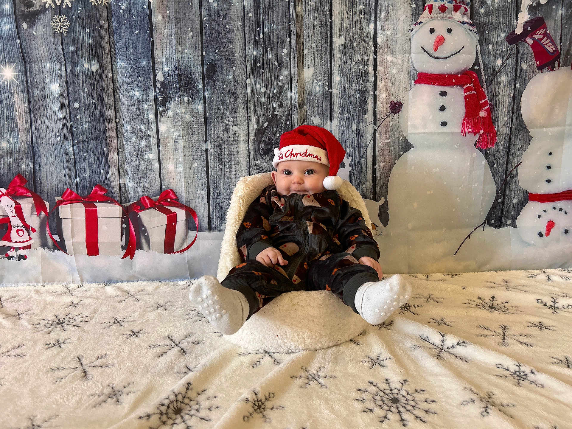 Noah joined the competition — help win amazing prizes! baby, child, santa_hat, pajamas, chair, snowman, gift_box, ribbon, snowflakes, blanket, holiday, christmas, winter, smile, festive, indoor, decoration, background, cute, person