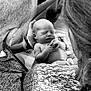 Kolter is registered to the contest to win money with this photo: baby, newborn, infant, adult, hands, blanket, knitwear, black_and_white, portrait, sleeping, close_up, family, love, tenderness, skin, person, head, holding, caring, indoor