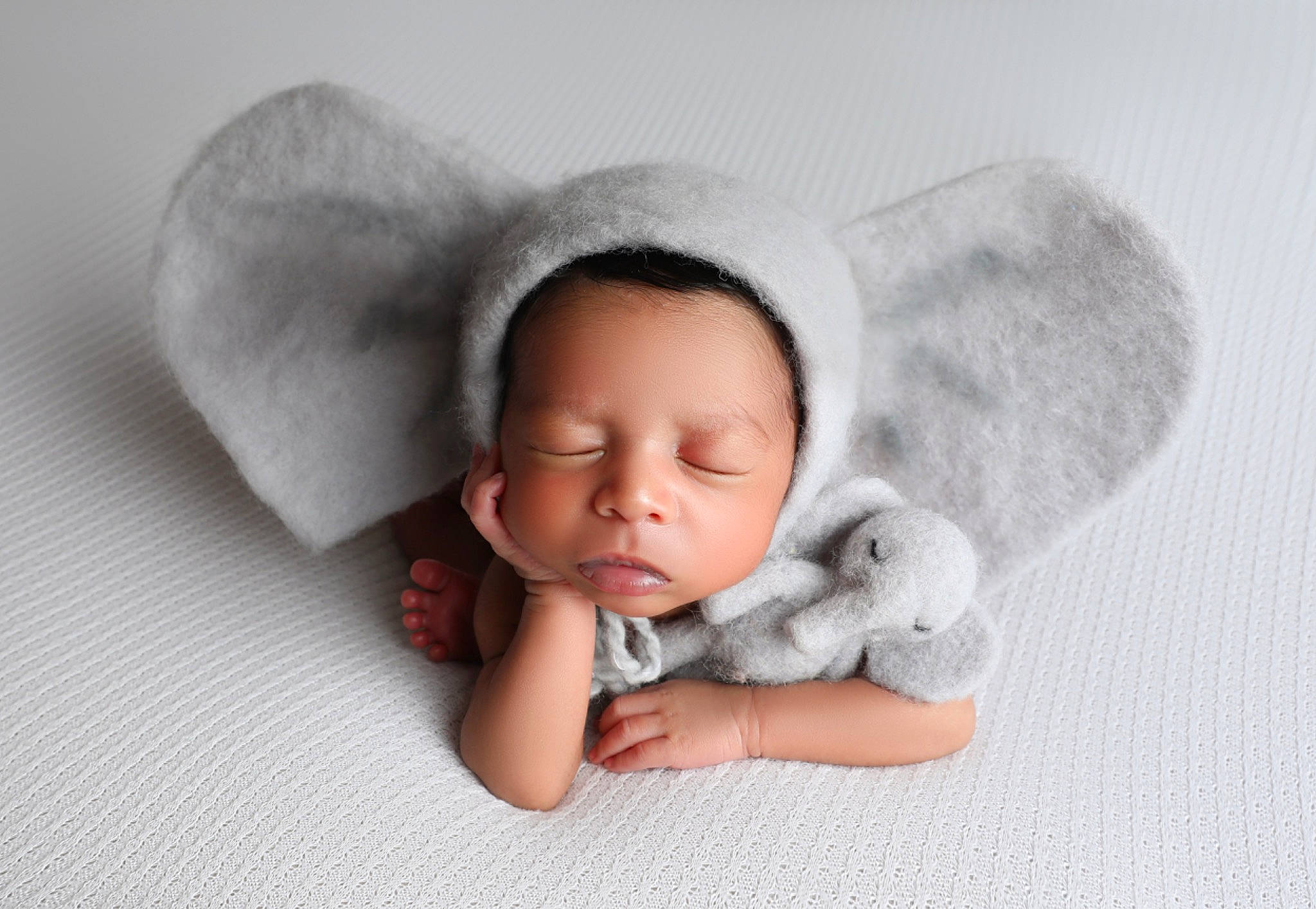 Jericho is registered to the contest to win money with this photo: arm, baby, baby_sleeping, baby_toddler_clothing, cap, cheek, comfort, gesture, grey, hand, happy, headgear, human_body, linens, lip, nose, person, skin, sleeve, toddler