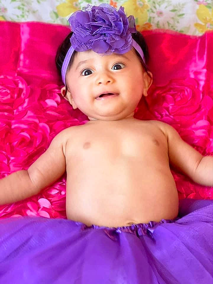 Bryanna joined the competition — help win amazing prizes! aqua, baby_toddler_clothing, blue, child, dress, face, facial_expression, fun, hairstyle, happy, headpiece, headwear, iris, magenta, person, petal, pink, purple, skin, smile