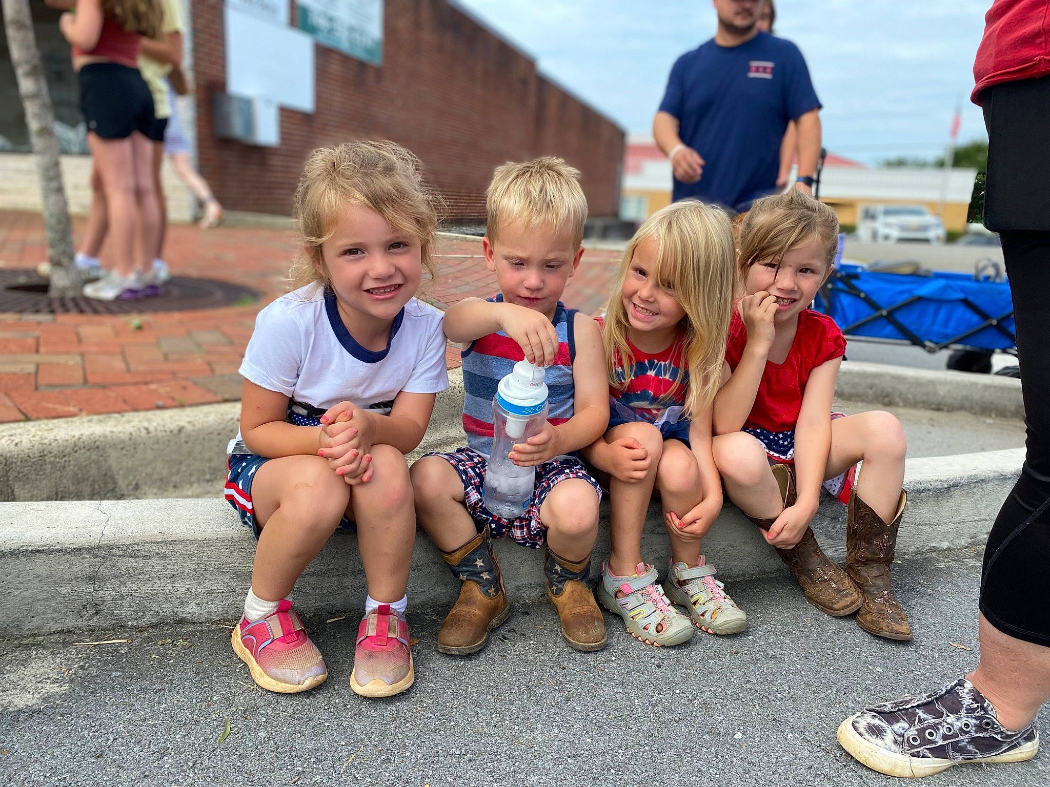 Ava is registered to the contest to win money with this photo: blurred, clothing, cloud, event, footwear, fun, grass, hairstyle, happy, joy, leg, leisure, person, recreation, shoe, shorts, sky, smile, sneakers, style