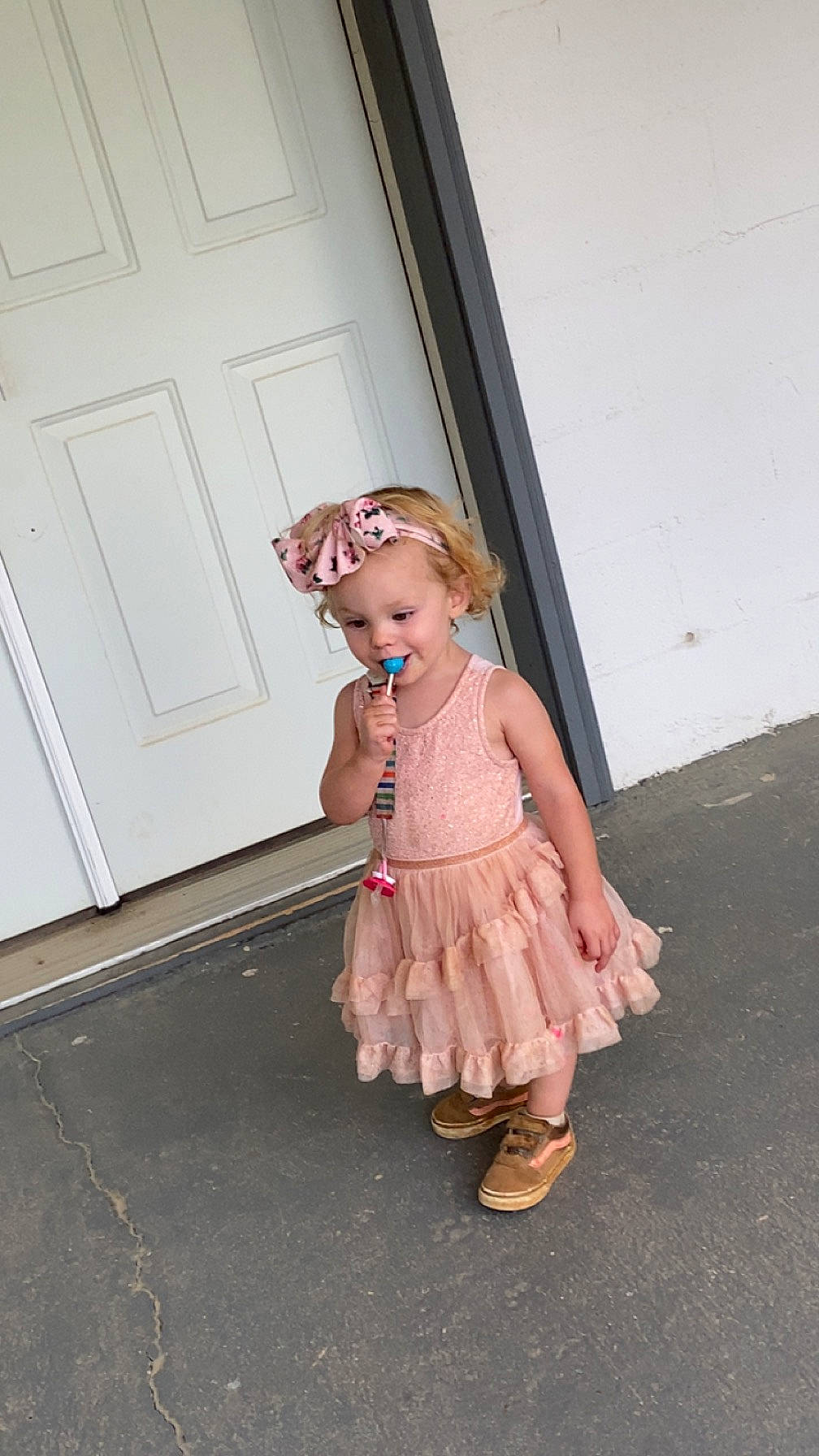 Aryanna is registered to the contest to win money with this photo: baby_toddler_clothing, child, day_dress, door, dress, fashion_design, flooring, foot, fun, headwear, home_door, human_leg, knee, pattern, peach, person, sandal, sleeve, thigh, toddler