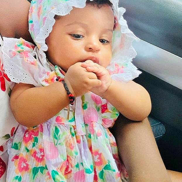 Kerri is registered to the contest to win money with this photo: baby, child, floral_dress, bonnet, arm, car_interior, cute, curious, person, hand, sitting, infant, clothing, colorful, portrait, young_child, adorable, indoors, seat, skin