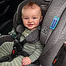 baby, child, car_seat, gray, smile, mohawk, hair, seatbelt, infant, clothing, striped_pajamas, car_interior, window, door, safety, happy, cute, young, person, seat