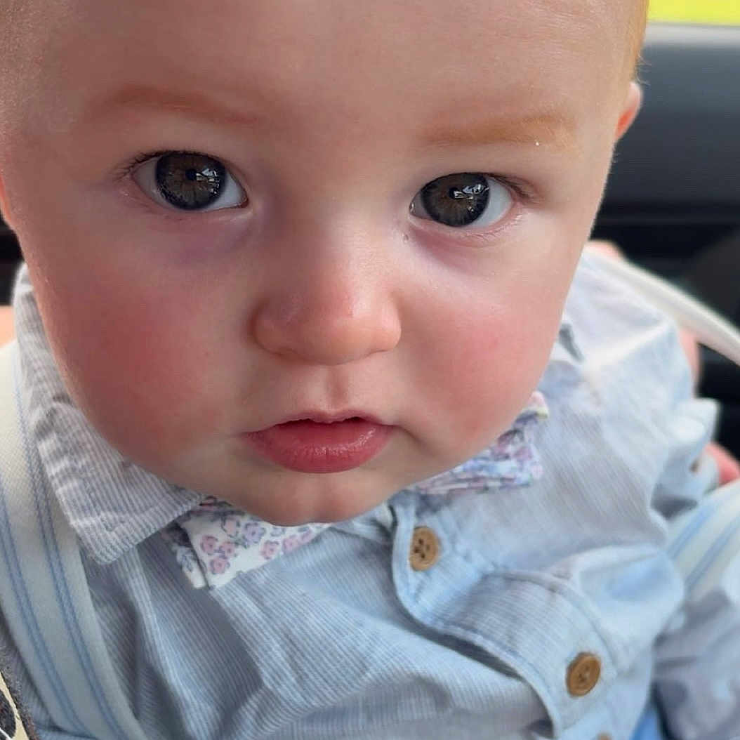 Josiah joined the competition — help win amazing prizes! baby, child, face, eyes, rosy_cheeks, shirt, buttoned_shirt, collar, curious_expression, closeup, portrait, person, young_child, cute, indoor, skin, hair, hand, seated, looking