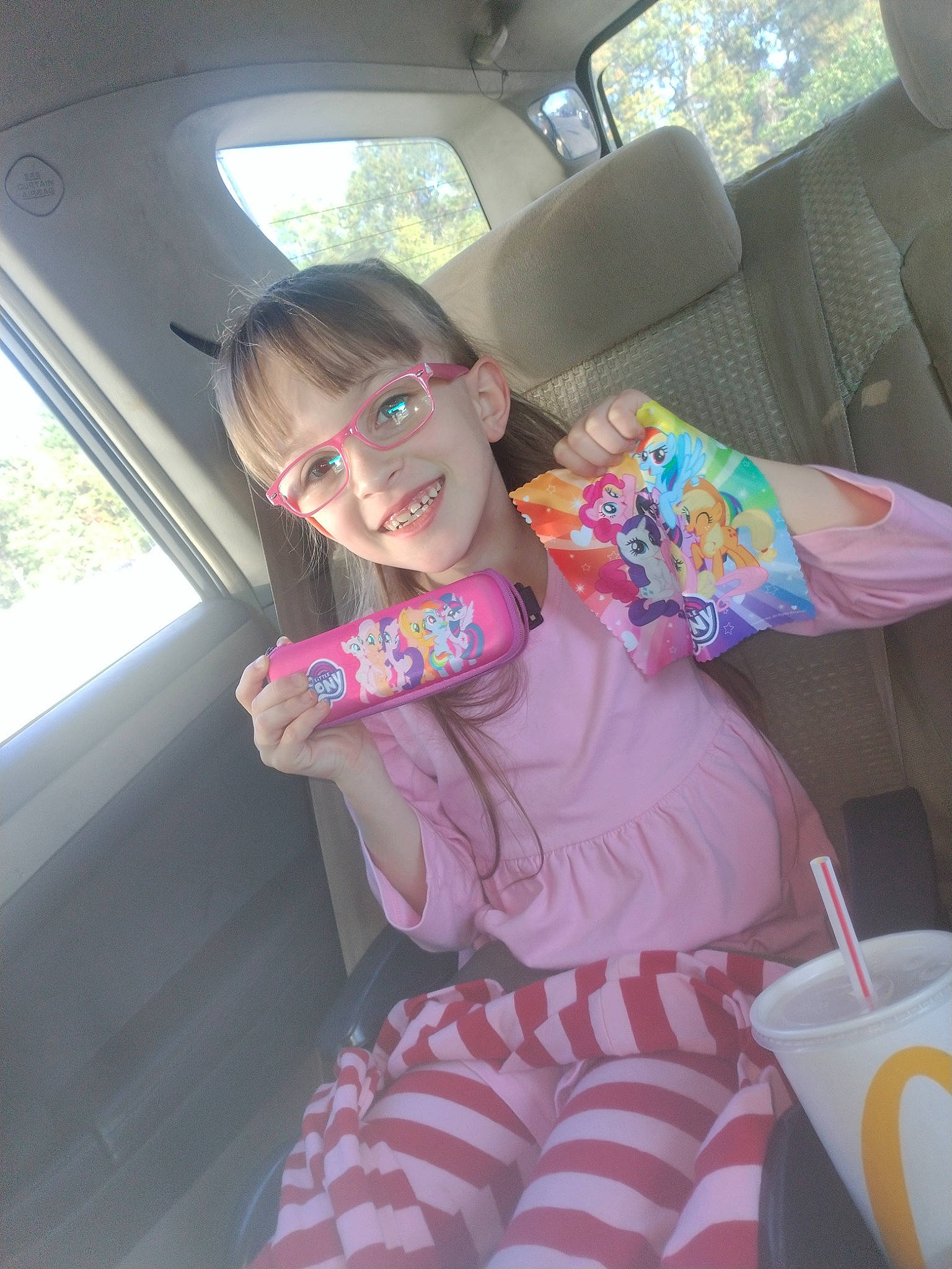 Preslee is registered to the contest to win money with this photo: auto_part, automotive_exterior, baby_toddler_clothing, car, car_seat, car_seat_cover, comfort, family_car, fun, joy, motor_vehicle, person, seat_belt, sitting, smile, steering_wheel, toddler, toy, vehicle, vehicle_door