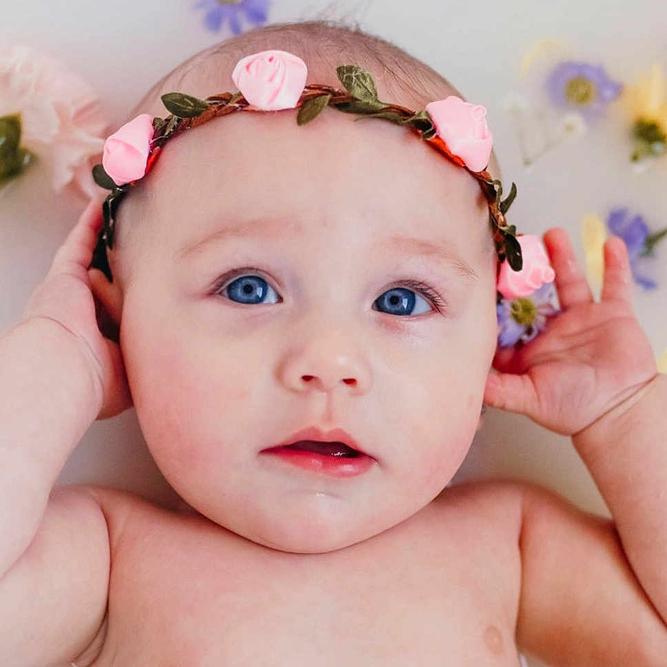 Laikyn is registered to the contest to win money with this photo: baby, cheek, child, child_model, ear, face, fashion_accessory, forehead, hair_accessory, hand, head, headband, headgear, headpiece, lip, mouth, person, photography, pink, skin