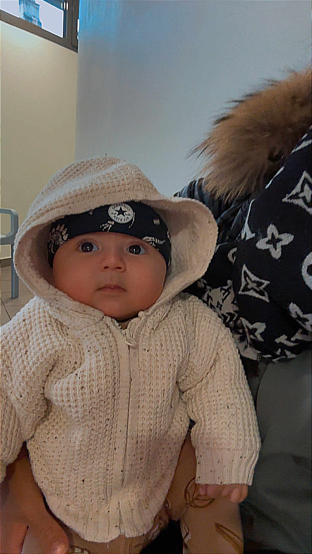 Hatem participe au concours pour gagner de l'argent avec cette photo : baby, child, hoodie, knitted, headband, person, clothing, indoor, portrait, cute, warm, holding, face, expression, fashion, jacket, pattern, hand, young, cozy