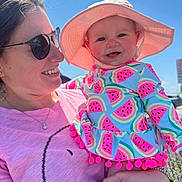 Kaylee Ryan is registered to the contest to win money with this photo: baby, blue_sky, bracelet, child, colorful_clothing, daylight, happy, hat, holding, jewelry, nature, outdoor, person, pink_shirt, portrait, smiling, sunglasses, sunhat, watermelon_pattern, woman