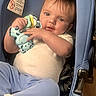 baby, child, car_seat, toy, giraffe_toy, blue, white_shirt, light_blue_pants, infant, cute, smiling, indoor, seat_belt, person, holding, face, head, hands, clothing, floor