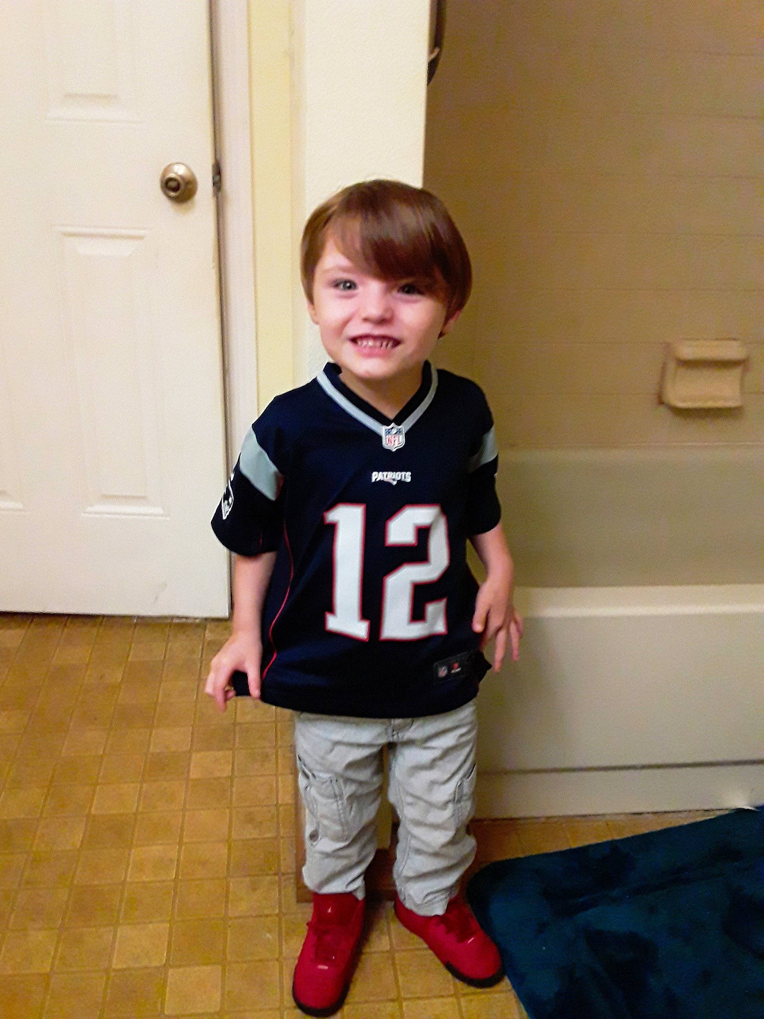 Jakobe is registered to the contest to win money with this photo: arm, child, clothing, cool, footwear, joint, joy, knee, leg, male, outerwear, person, shoe, shoulder, sleeve, sportswear, standing, t_shirt, toddler, trousers