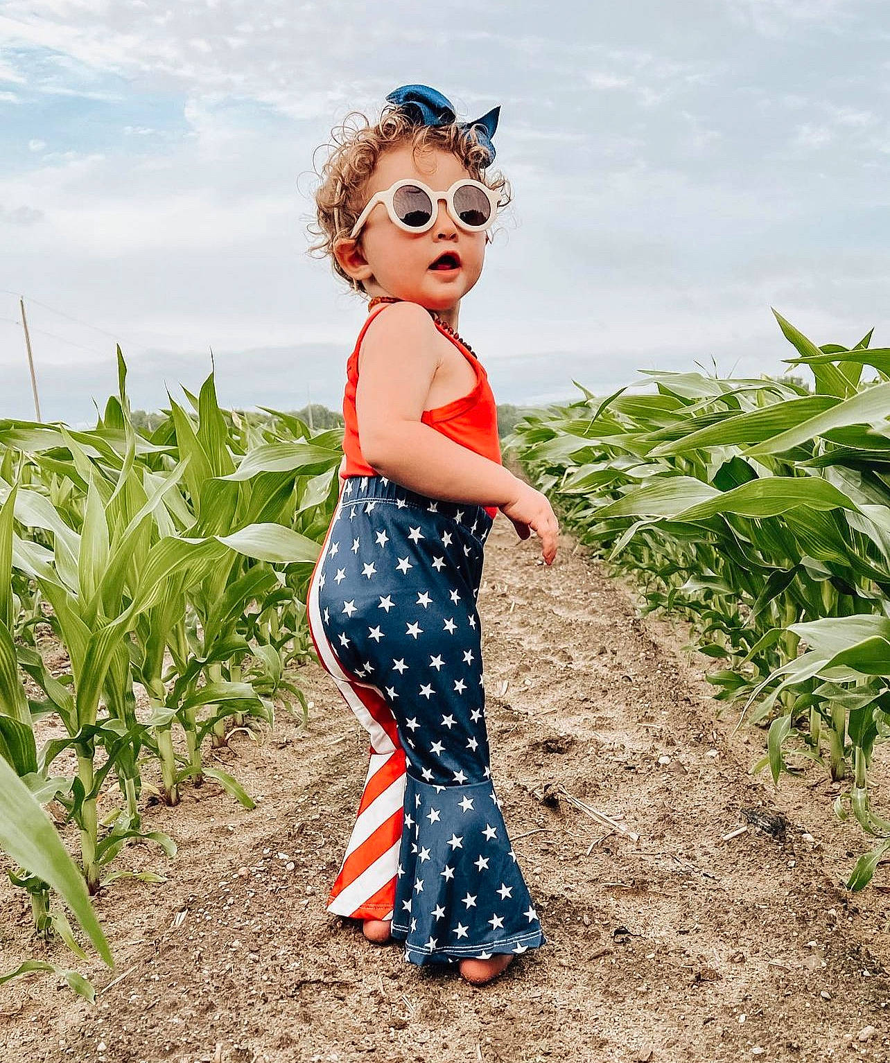 Ana joined the competition — help win amazing prizes! agriculture, blond, child, cloud, electric_blue, eyewear, fashion_design, field, fun, grass, grassland, happy, landscape, pattern, people_in_nature, person, plant, sky, soil, travel
