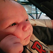 Mason joined the competition — help win amazing prizes! baby, black_sleeve, bottle, close_up, clothing, cute, expression, face, fingers, hand, indoor, infant, newborn, person, portrait, red_letter, skin, soft_blanket, thoughtful, young_child