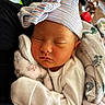 Olivia joined the competition — help win amazing prizes! newborn, baby, sleeping, hat, blanket, cute, cozy, indoor, child, infant, face, person, rest, soft, warm, cat, animal, pet, comfort, peaceful