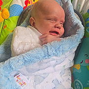 Arlo is registered to the contest to win money with this photo: baby, blanket, blue, smiling, infant, baby_seat, colorful, giraffe_print, soft, cozy, sleeping, cute, child, wrapped, comfort, indoors, toy, fabric, happy, newborn