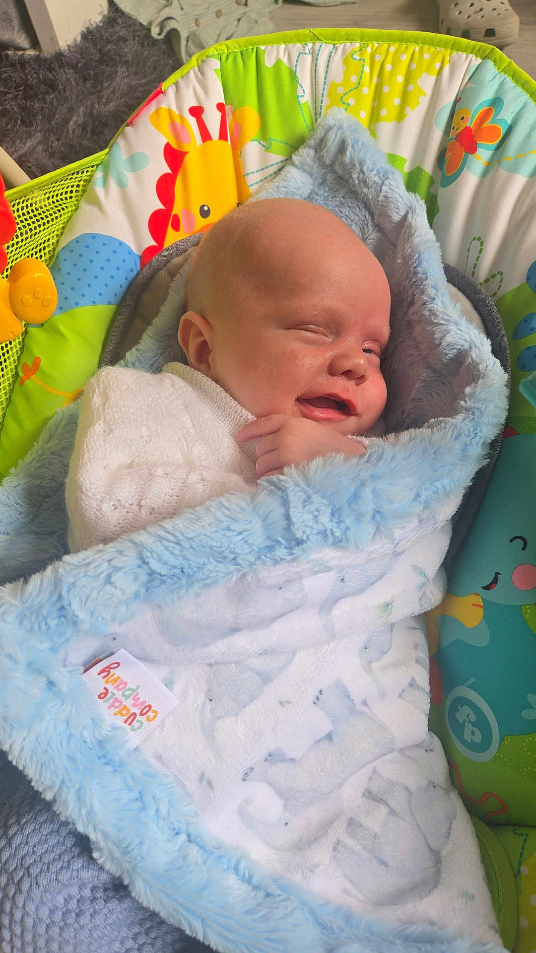 Arlo is registered to the contest to win money with this photo: baby, blanket, blue, smiling, infant, baby_seat, colorful, giraffe_print, soft, cozy, sleeping, cute, child, wrapped, comfort, indoors, toy, fabric, happy, newborn