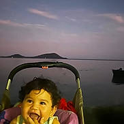 Toriki participe au concours pour gagner de l'argent avec cette photo : baby, child, clouds, curly_hair, dusk, evening, happy, hills, lake, nature, outdoor, person, portrait, relaxation, sitting, sky, smiling, stroller, toddler, water