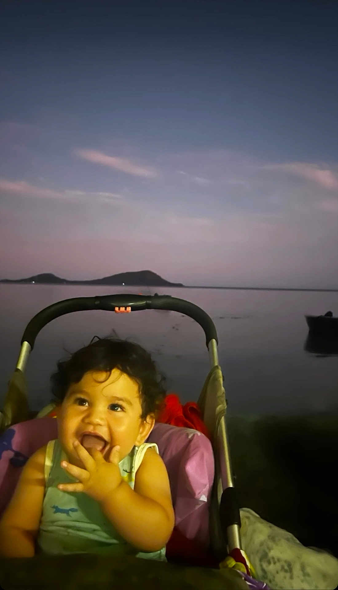 Toriki participe au concours pour gagner de l'argent avec cette photo : baby, child, clouds, curly_hair, dusk, evening, happy, hills, lake, nature, outdoor, person, portrait, relaxation, sitting, sky, smiling, stroller, toddler, water