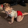 Sahara is registered to the contest to win money with this photo: baby, child, crawling, carpet, red_shorts, red_bow, sunlight, shadow, indoor, person, legs, sneakers, socks, couch, leather, floor, cute, infant, young_child, home