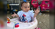 Sahara is registered to the contest to win money with this photo: baby, background, blue_bow, bubbles, child, concrete_ground, curious, daylight, fun, open_car_door, outdoor, plastic_toy, playtime, purple_shoes, red_bracelet, summer, toddler, toy_car, walker, white_shirt