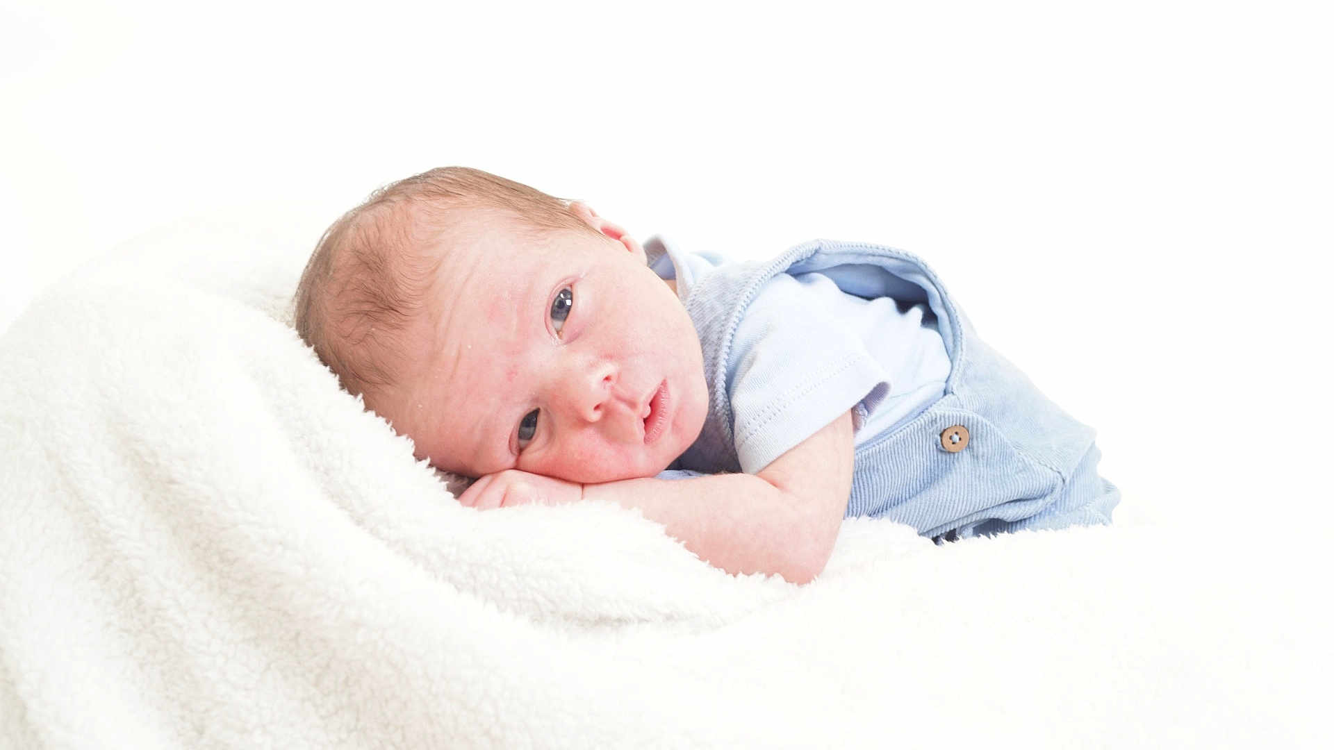 Euan is registered to the contest to win money with this photo: baby, infant, newborn, blanket, soft, blue_clothing, face, head, skin, lying_down, resting, cute, small, child, portrait, indoors, cozy, peaceful, sleepy, person