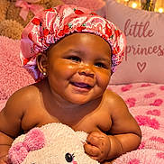 Abbiegale joined the competition — help win amazing prizes! baby, child, smile, pink, bonnet, plush_toy, teddy_bear, blanket, pillow, cute, happy, indoors, face, portrait, soft_texture, cozy, decor, earrings, infant, person