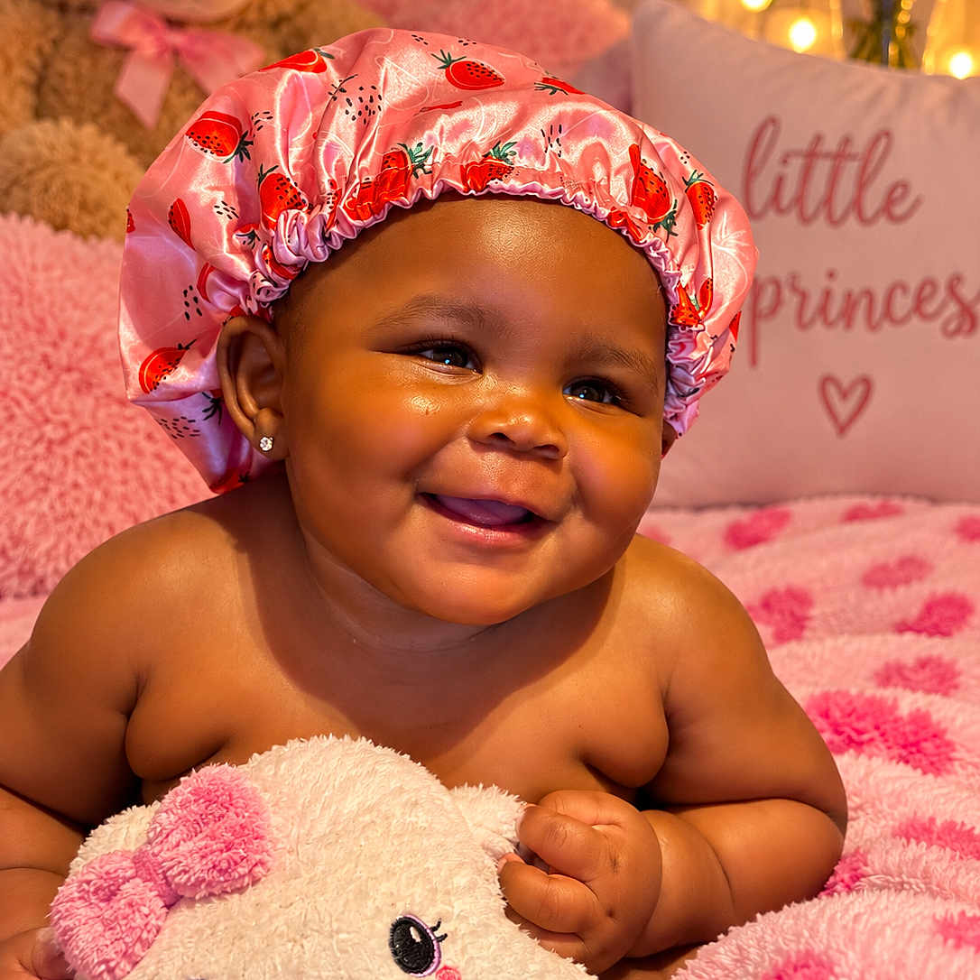 Abbiegale joined the competition — help win amazing prizes! baby, child, smile, pink, bonnet, plush_toy, teddy_bear, blanket, pillow, cute, happy, indoors, face, portrait, soft_texture, cozy, decor, earrings, infant, person